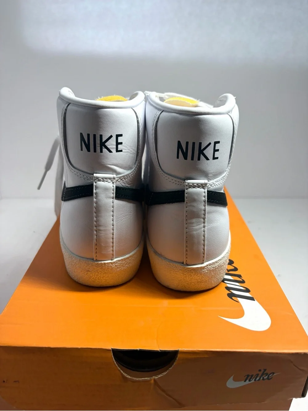 Nike unisex White High-Top Sneakers with Black Swoosh and Yellow Tongue Tab